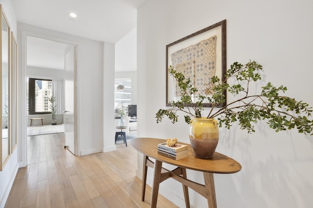 75 Wall St Unit 34M, New York City, NY 10005 - hall with healthy amount of natural light, light wood-style flooring, baseboards, and recessed lighting