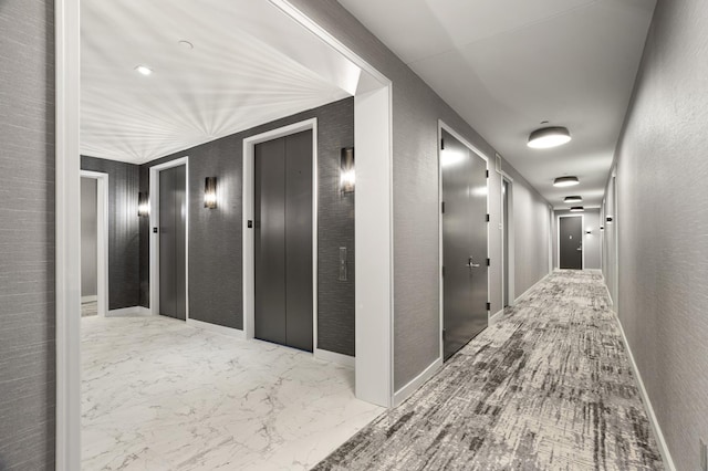 75 Wall St Unit 34M, New York City, NY 10005 - hallway with elevator, marble finish floors, a textured wall, and baseboards