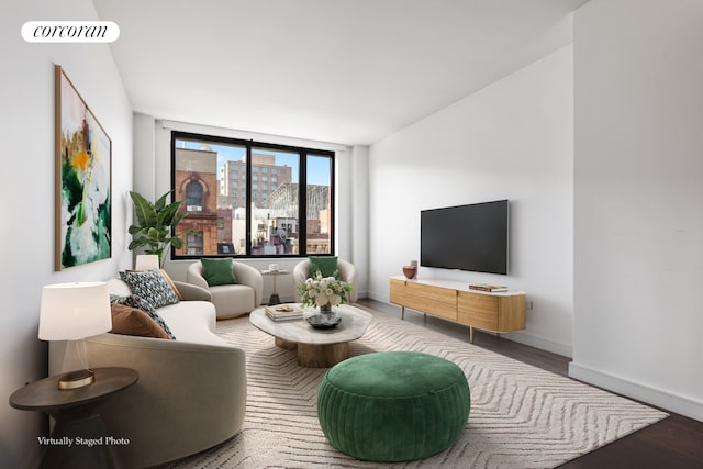 living area with visible vents, baseboards, and wood finished floors