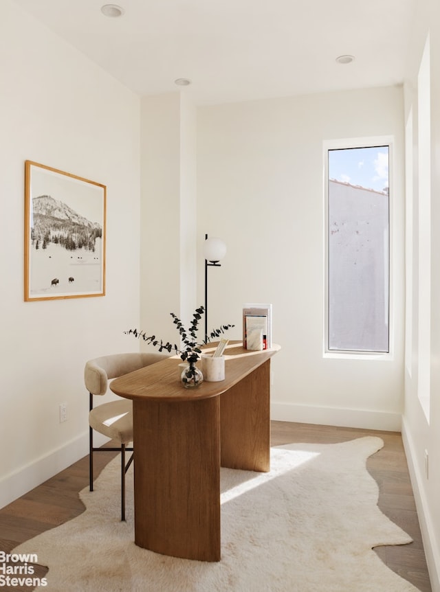 office area featuring light wood-style flooring and baseboards