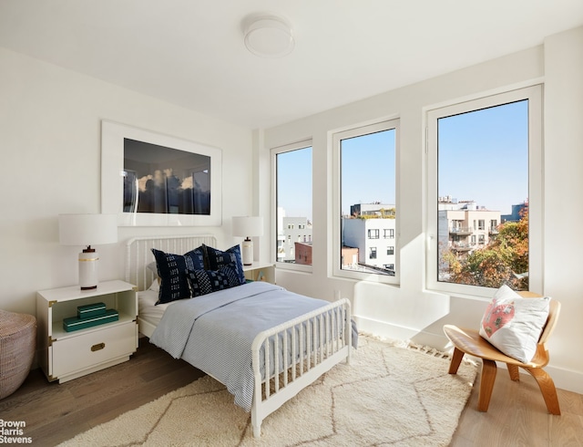 bedroom featuring baseboards and wood finished floors