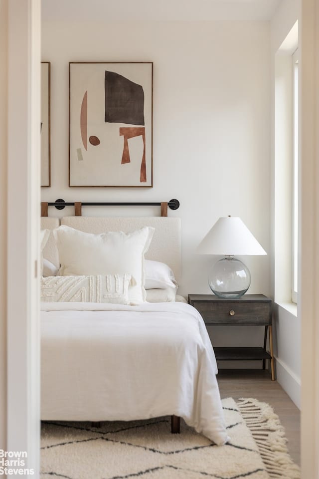 bedroom featuring baseboards and wood finished floors