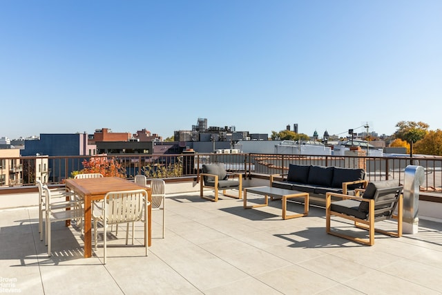 view of patio with outdoor dining area, an outdoor hangout area, and a view of city