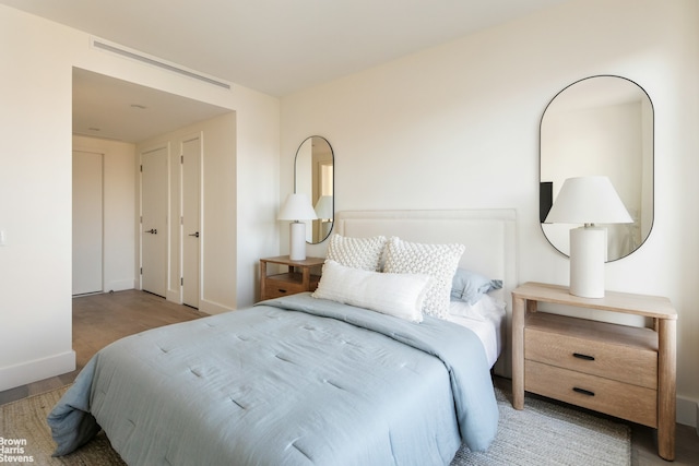 bedroom featuring wood finished floors and baseboards