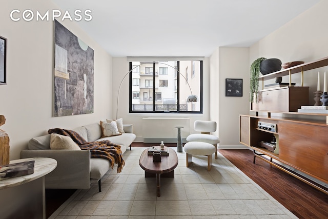 living room with baseboards and wood finished floors