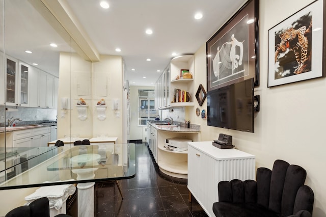 kitchen featuring white cabinetry, open shelves, a sink, and recessed lighting