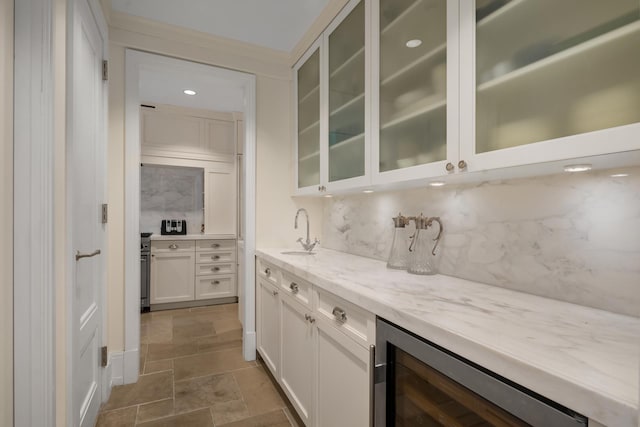 40 E 66th St Unit 4B, New York City, NY 10065 - indoor bar featuring wine cooler, tasteful backsplash, and stone finish floors
