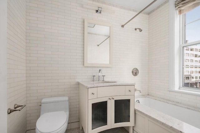 full bathroom with vanity, shower / tub combination, tile walls, and toilet