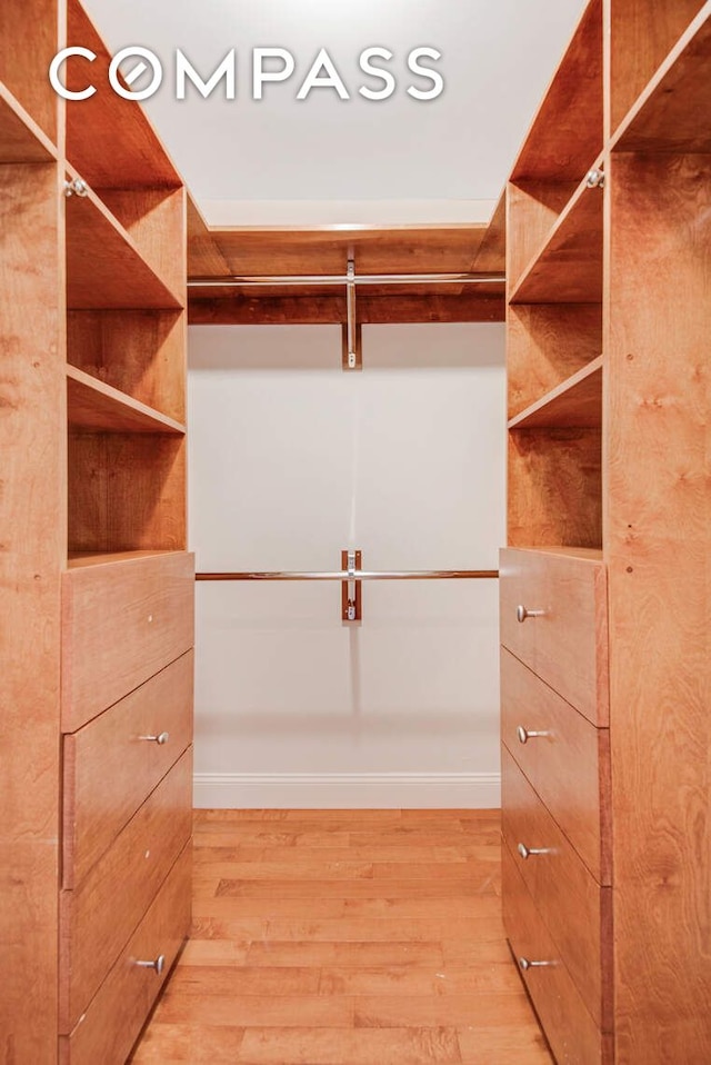 walk in closet featuring light wood finished floors