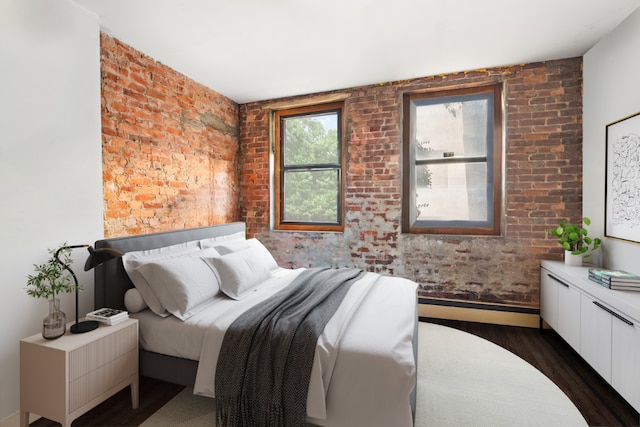 bedroom with dark hardwood / wood-style flooring and brick wall