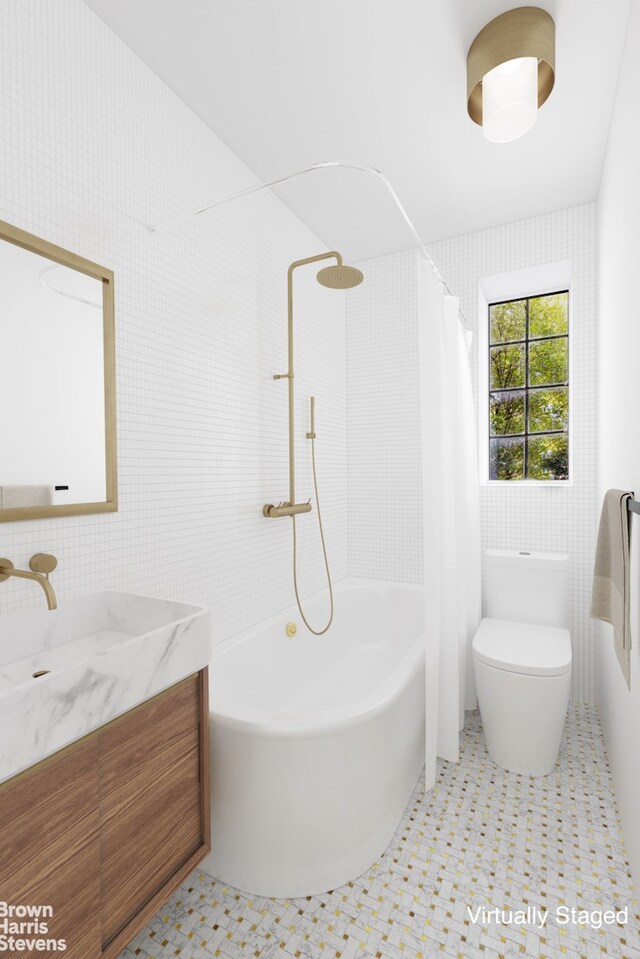 full bath featuring toilet, tile walls, and vanity