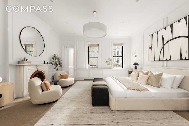 bedroom featuring carpet, a fireplace, and crown molding