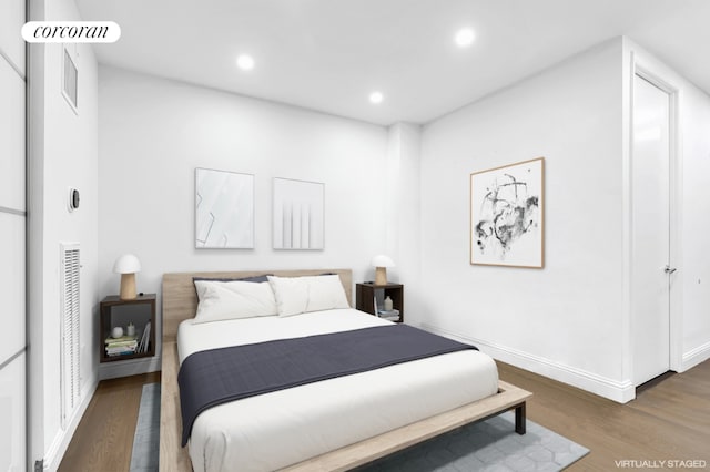 bedroom with dark wood-type flooring