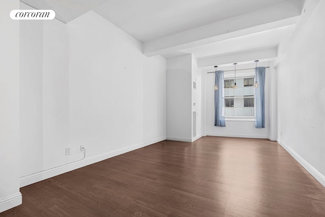 unfurnished room featuring dark wood-type flooring and beamed ceiling