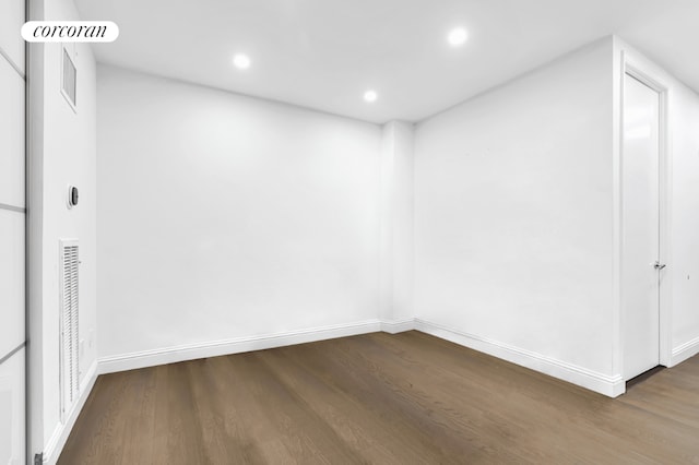 spare room with dark hardwood / wood-style flooring