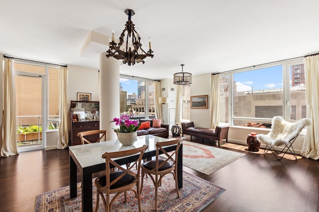 dining room featuring a chandelier, a healthy amount of sunlight, and dark wood-style floors