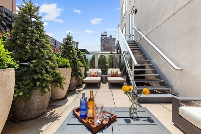 view of patio with stairs and a city view