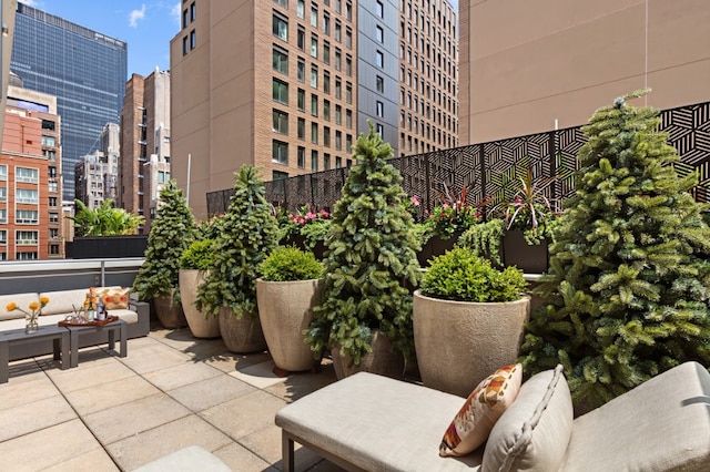 view of patio featuring an outdoor living space and a view of city