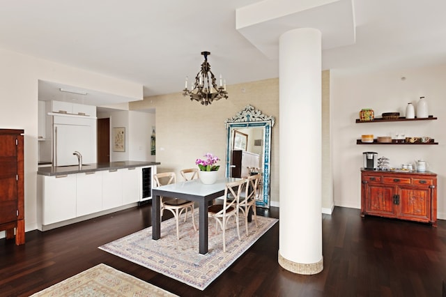 dining area with beverage cooler, baseboards, dark wood-style floors, and ornate columns