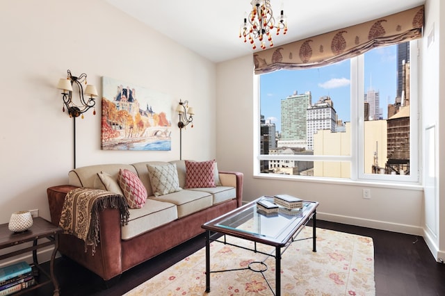 living area featuring a view of city, wood finished floors, and baseboards