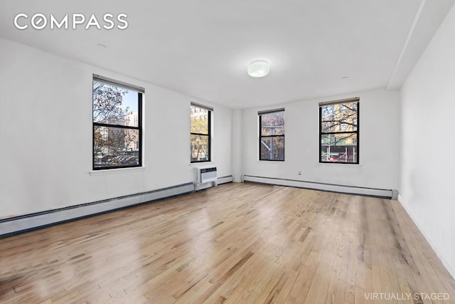 2792 Frederick Douglass Blvd Unit 2B, New York City, NY 10039 - empty room with baseboard heating, wood finished floors, and a baseboard heating unit