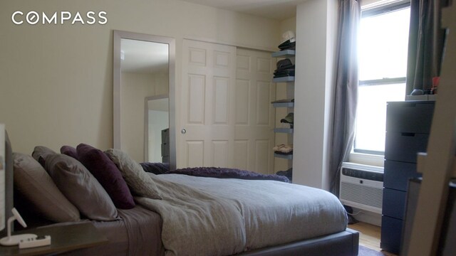 bedroom with hardwood / wood-style floors and a closet