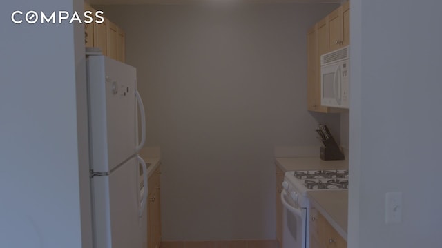 kitchen featuring white appliances and light countertops