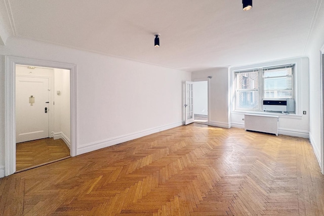 spare room featuring cooling unit, radiator, and baseboards