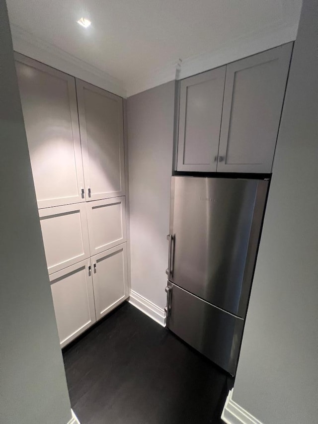 kitchen featuring dark hardwood / wood-style flooring and stainless steel refrigerator