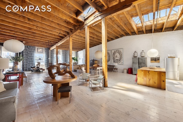 living room with lofted ceiling with skylight and wood-type flooring