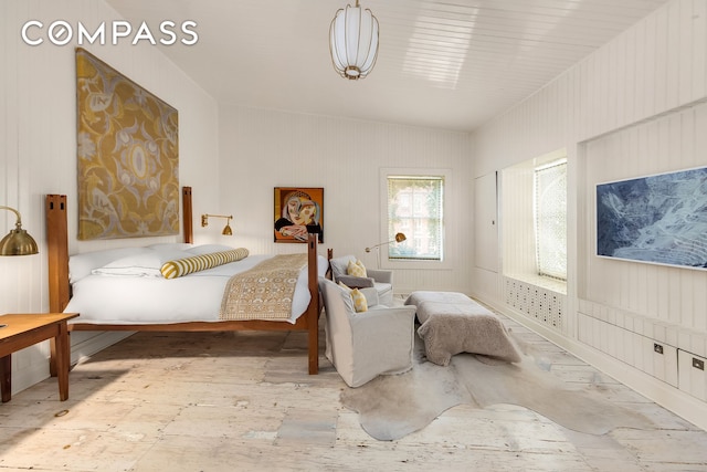 bedroom featuring wood finished floors and vaulted ceiling