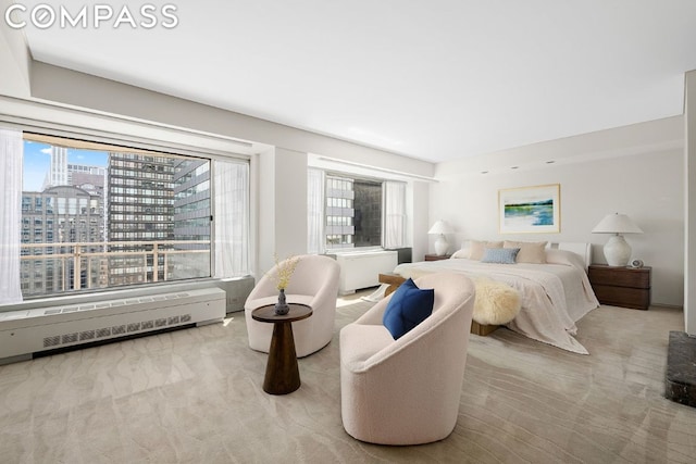 carpeted bedroom with radiator and multiple windows