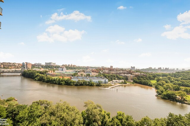 birds eye view of property with a view of city and a water view