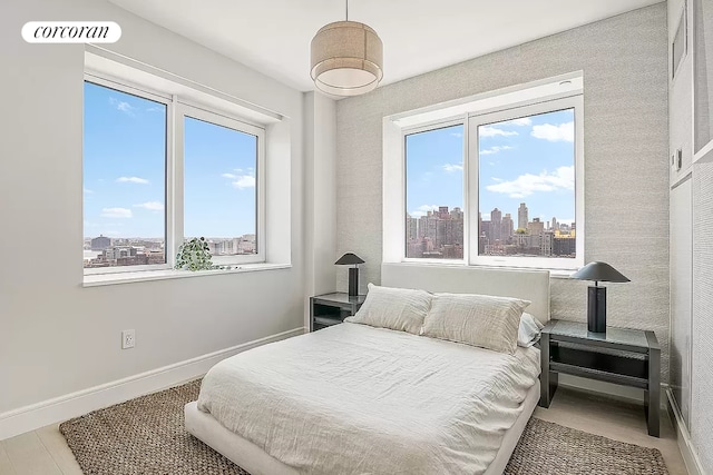 bedroom with multiple windows and wood-type flooring