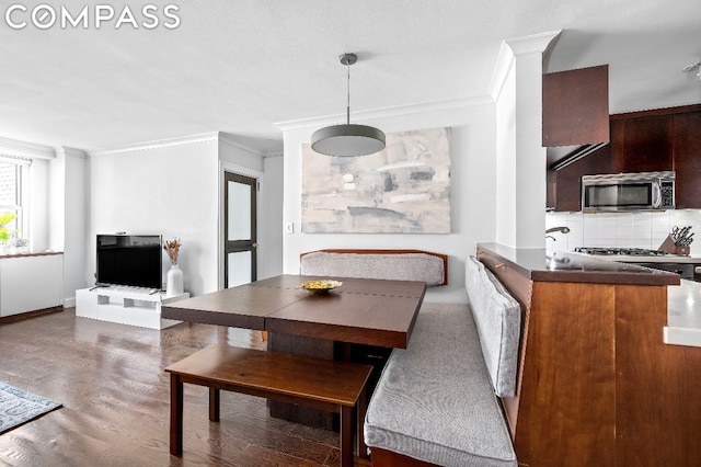 dining space featuring dark hardwood / wood-style floors and ornamental molding