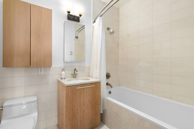 full bathroom featuring shower / bath combination with curtain, vanity, toilet, and tile walls