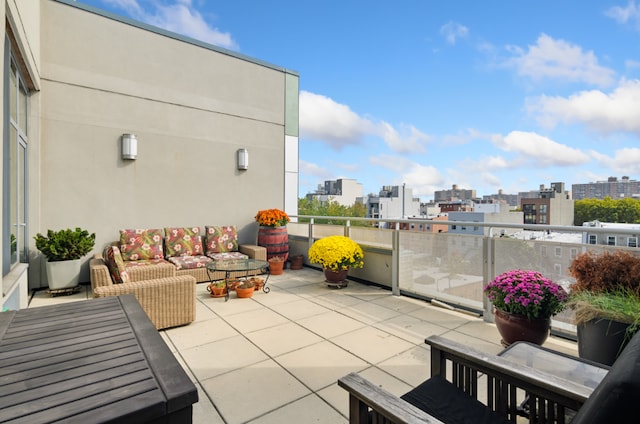 view of patio with an outdoor living space and a balcony