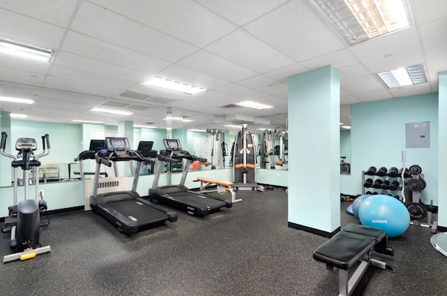 workout area with electric panel and a drop ceiling