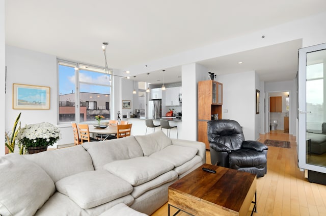 living room featuring plenty of natural light and light hardwood / wood-style floors