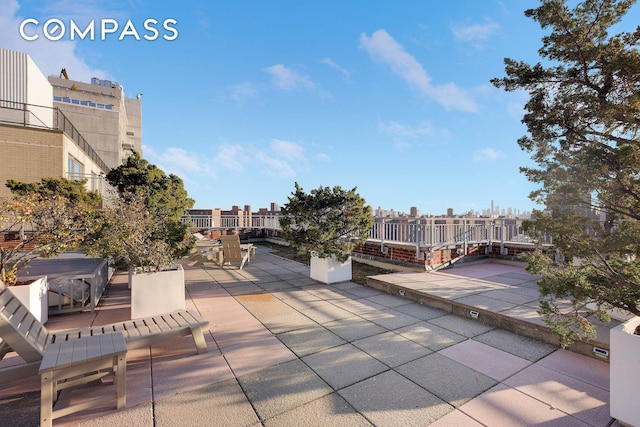 view of patio / terrace featuring a view of city and outdoor dining space