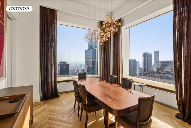 dining area with light parquet flooring, a chandelier, and a wealth of natural light