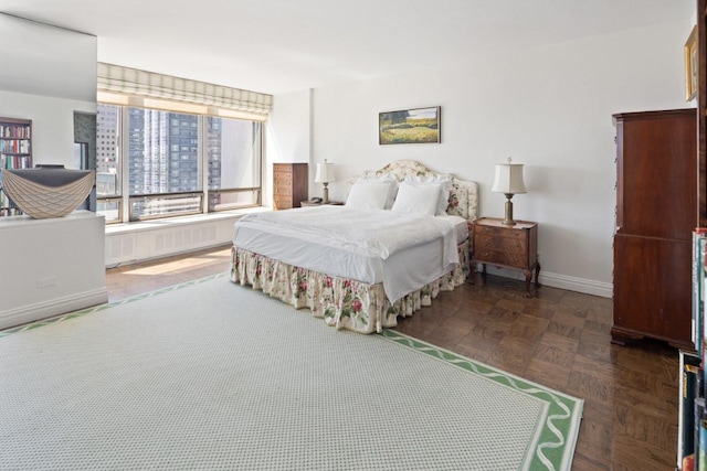 bedroom featuring dark parquet flooring and radiator heating unit