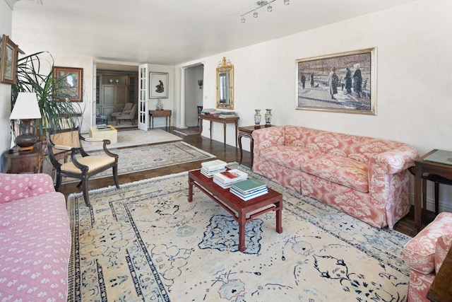 living room with hardwood / wood-style floors and track lighting