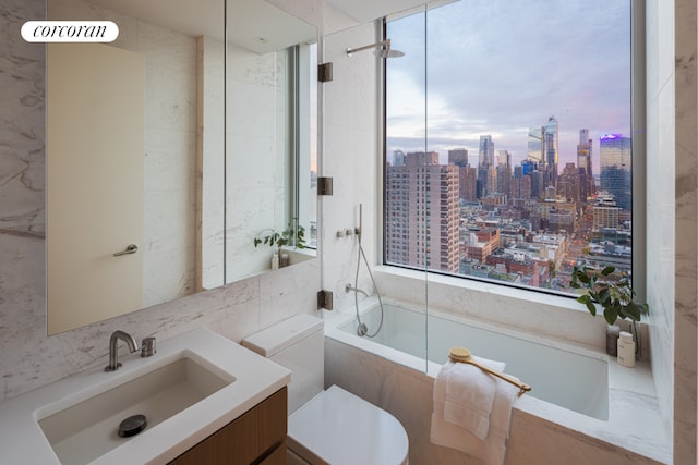 full bathroom with tile walls, tiled shower / bath combo, vanity, decorative backsplash, and toilet