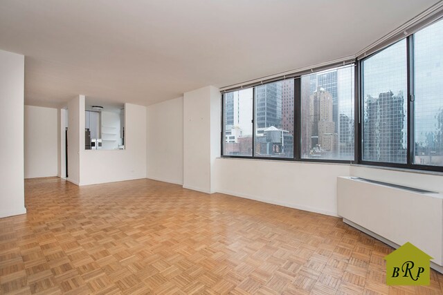 kitchen with light tile patterned flooring, appliances with stainless steel finishes, sink, and white cabinets