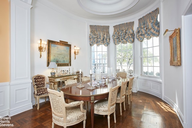 dining area with crown molding and dark parquet floors