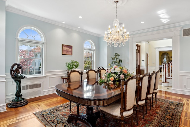 dining space featuring crown molding, wood finished floors, and recessed lighting