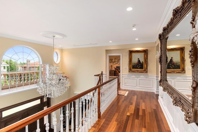 hall with crown molding, a chandelier, and dark wood-type flooring