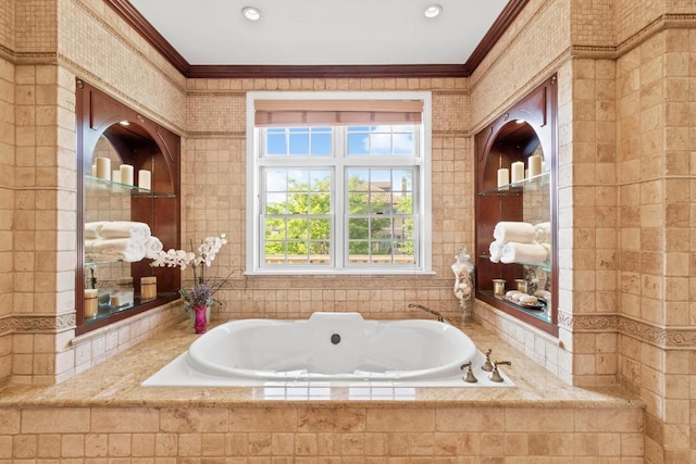 bathroom with ornamental molding and tiled bath