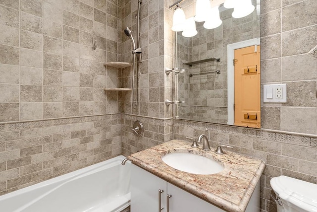 full bathroom featuring toilet, tile walls, vanity, tiled shower / bath combo, and decorative backsplash